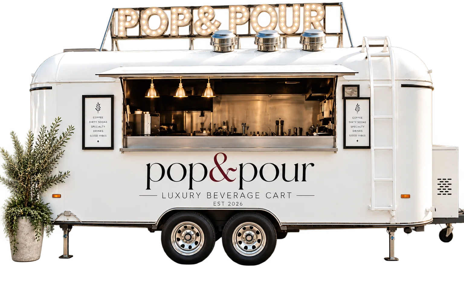 The Pop & Pour luxury beverage trailer with its marquee sign lit